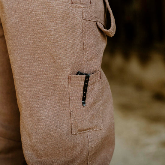Close-up of brown overalls with a blurred background
