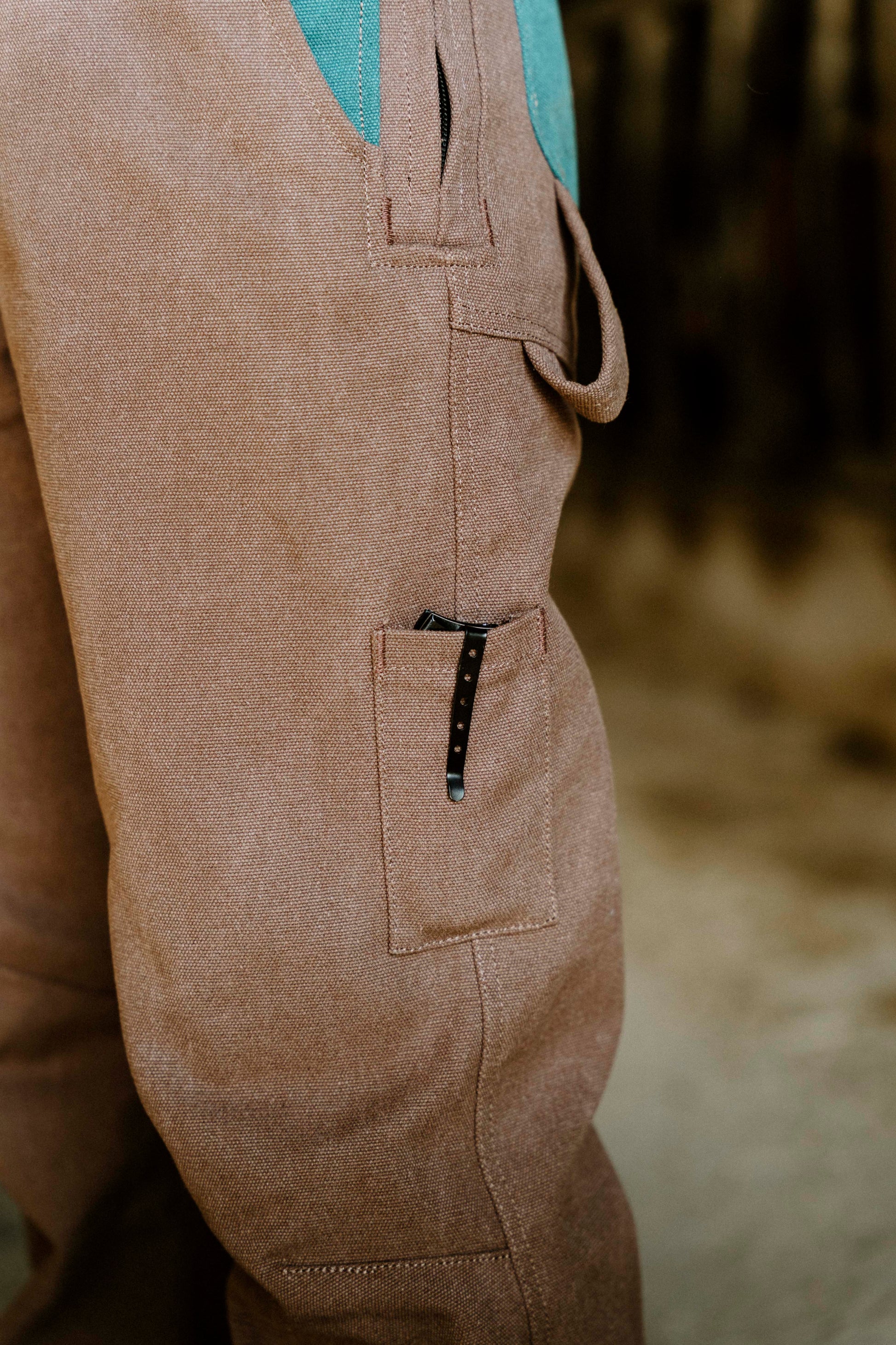 Close-up of brown overalls with a blurred background