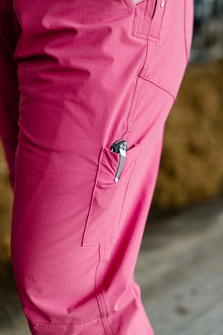 Close-up of pink overalls with a zipper pocket on a blurred background