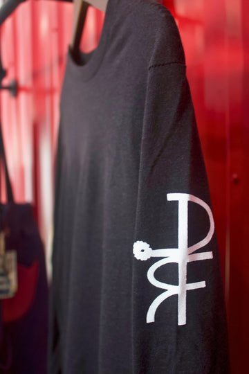 Black long-sleeve shirt with a white logo on a red background