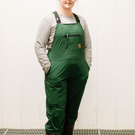 Lady standing in green overalls 